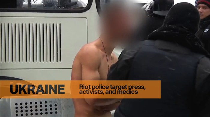 Ukrainian man held naked by police.